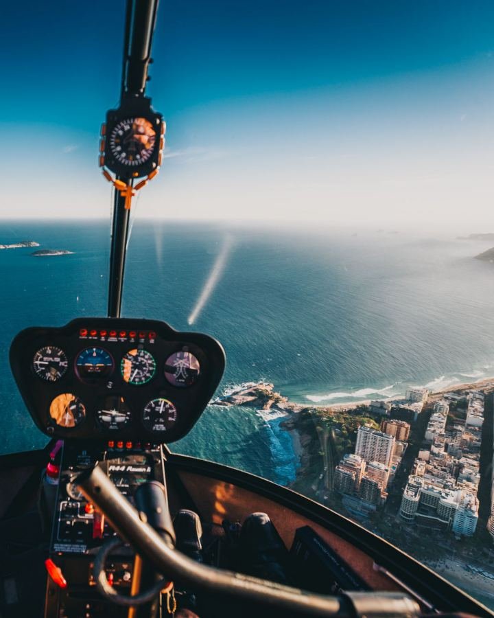 View from a helicopter cockpit over a coastline