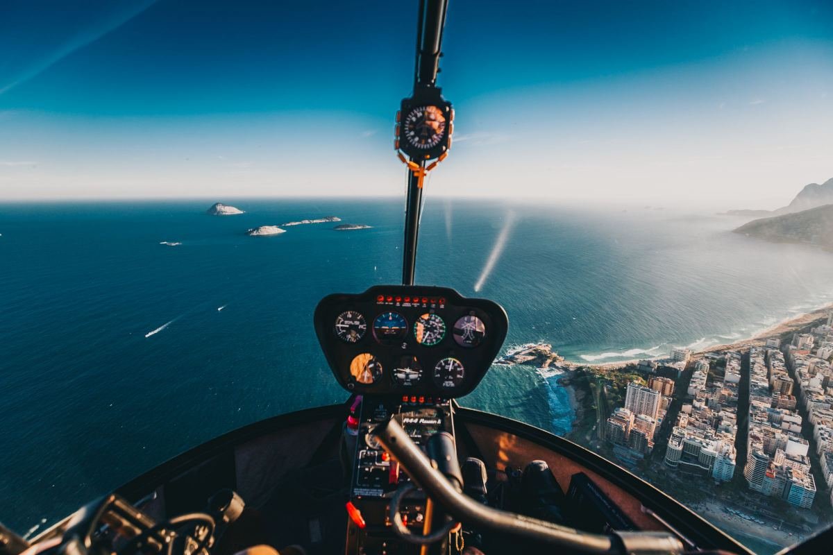 View from a helicopter cockpit over a coastline